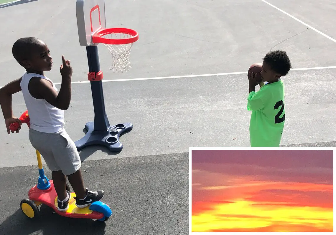 A young boy is playing basketball on the court.